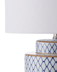 Blue and white ceramic table lamp with white shade up close 