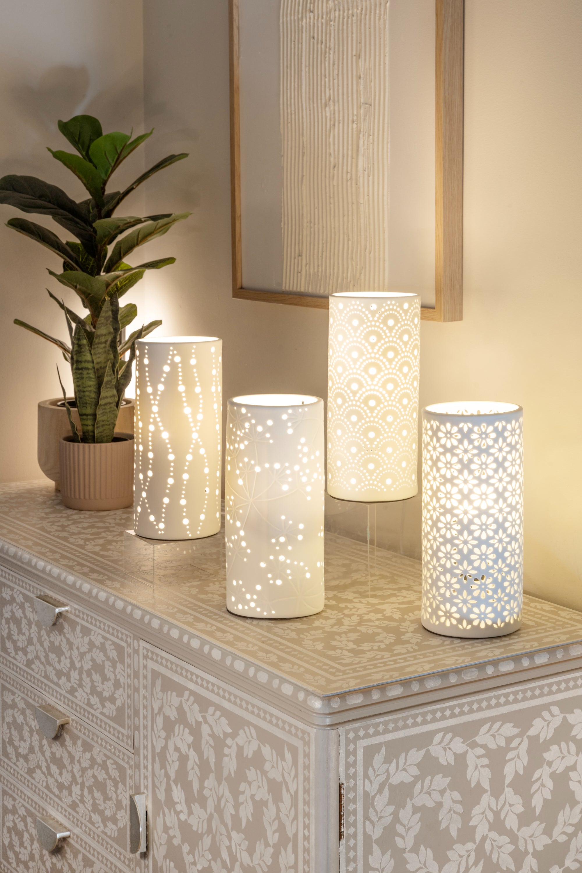 Four porcelian table lamps on a small buffet