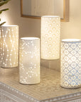 Four porcelian table lamps lit on a small buffet